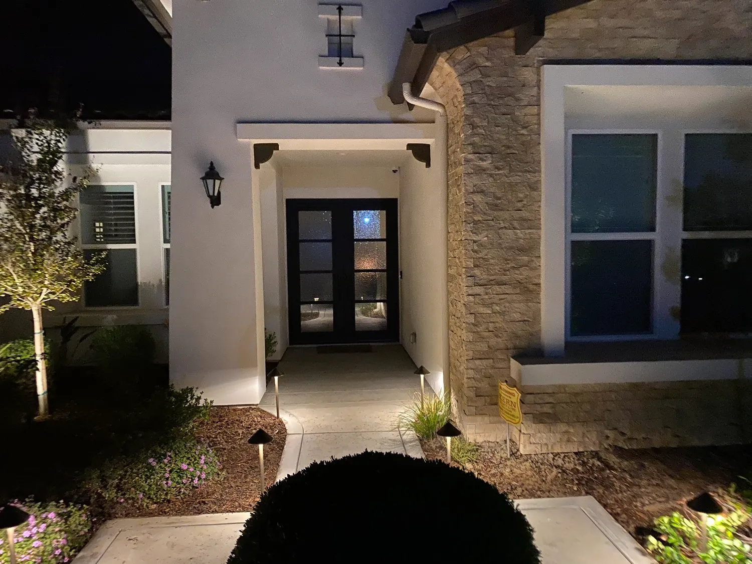 Front entry lighting and landscape uplighting at night